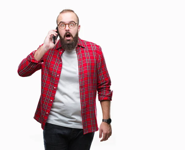 Smartphone'da izole arka plan üzerinde bir sürpriz yüz, korkuyor ve heyecanlı korku ifadesi ile şok korkmuş konuşan genç beyaz hipster adam