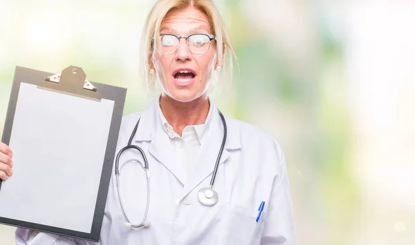 Middle Age Blonde Doctor Woman Holding Clipboard Isolated Background Scared — Stock Photo, Image