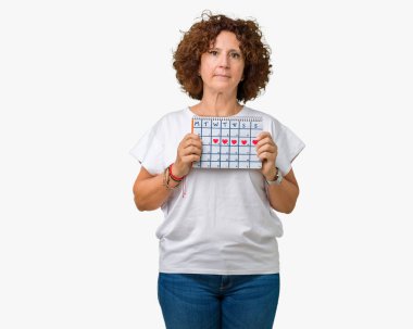 Adet takvim acımak yüz ciddi düşünüyorum üstünde kendine güvenen bir ifade ile izole arka plan üzerinde tutan orta ager üst düzey kadın