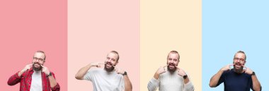 Kendinden emin gösterilen ve işaret parmakları diş ve ağız ile gülümseyen izole renkli çizgili arka plan üzerinde sakallı genç adam kolaj. Sağlık kavramı.