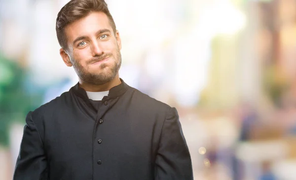 Joven Sacerdote Cristiano Católico Sobre Fondo Aislado Soplando Mejillas Con —  Fotos de Stock