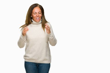 Arka plan deli kutluyor üzerinde kış kazak giyen güzel orta yaş yetişkin kadın izole ve crazy arms ile başarı için kaldırdı ve heyecanlı çığlık gözler kapalı. Kazanan kavramı