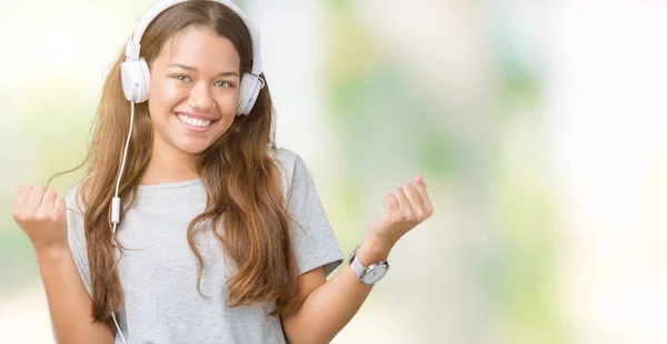 Молода Красива Жінка Навушниках Слухає Музику Ізольованому Фоні Святкуючи Здивований — стокове фото