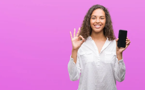 Young Hispanic Woman Using Smartphone Doing Sign Fingers Excellent Symbol — Stock Photo, Image