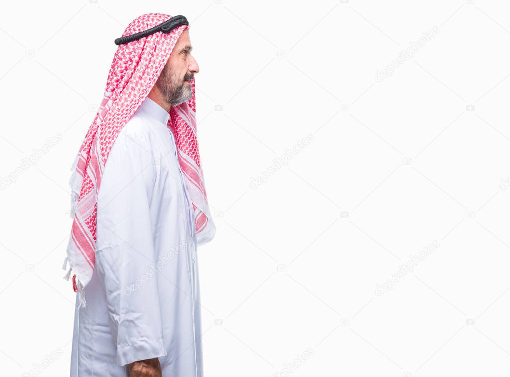Senior arab man wearing keffiyeh over isolated background looking to side, relax profile pose with natural face with confident smile.