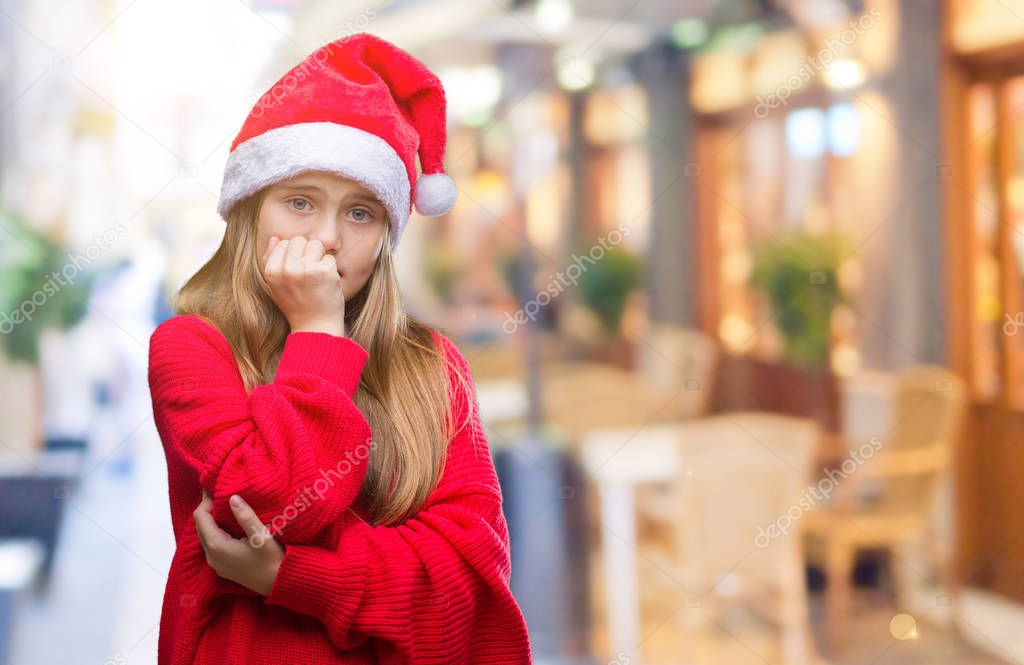 Young beautiful girl wearing christmas hat over isolated background looking stressed and nervous with hands on mouth biting nails. Anxiety problem.