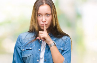 Dudaklarında parmak ile sessiz olmanı izole arka plan üzerinde genç Kafkas güzel kadın. Sessizlik ve gizli kavramı.