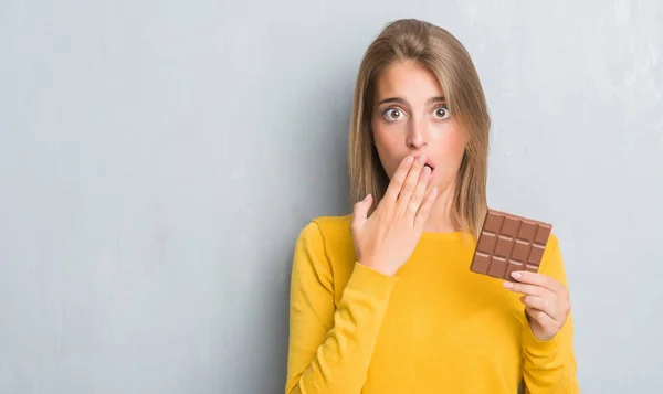 Schöne Junge Frau Über Grunge Grey Wall Eating Chocolate Bar — Stockfoto