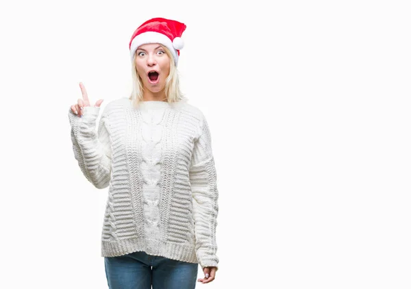 이상의 크리스마스 모자를 금발의 성공적인 아이디어와 손가락 가리키는 — 스톡 사진