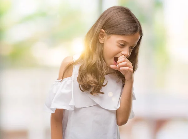 Brunette hispanic girl feeling unwell and coughing as symptom for cold or bronchitis. Healthcare concept.