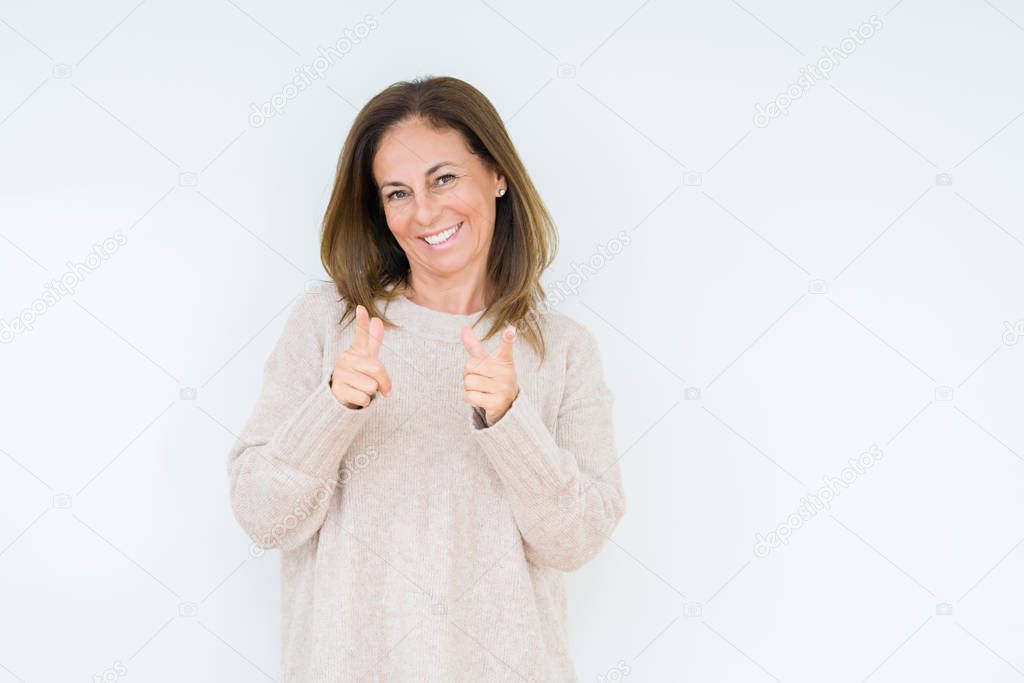 Beautiful middle age woman over isolated background pointing fingers to camera with happy and funny face. Good energy and vibes.