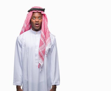 Geleneksel keffiyeh korkuyor ve şok sürpriz ifade, korku ve heyecan yüz ile izole arka plan üzerinde giyen genç Arapça Afrika adam.