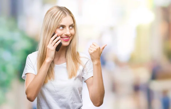 Young Beautiful Blonde Woman Talking Using Smartphone Isolated Background Pointing — Stock Photo, Image