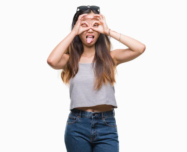 Young Asian Woman Wearing Sunglasses Isolated Background Doing Gesture Binoculars — Stock Photo, Image