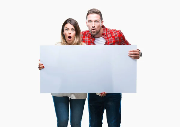 Young Couple Together Holding Blank Banner Isolated Background Scared Shock — Stock Photo, Image