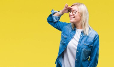 Genç güzel sarışın kadın üzerinde gözlük takan arka plan çok mutlu ve gülümseyen uzakta el ile üzerine kafa seyir izole. Arama kavramı.