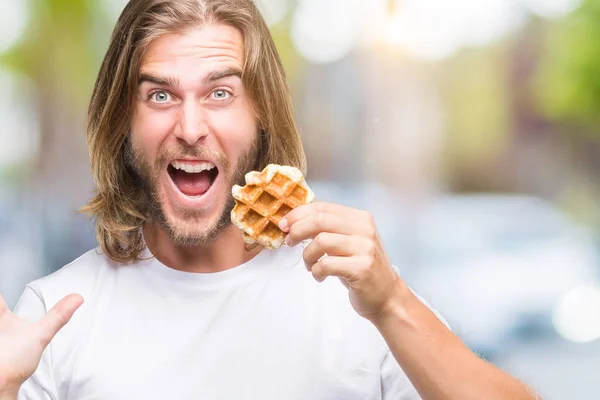 Young Handsome Man Long Hair Isolated Background Eating Waffle Very — Stock Photo, Image