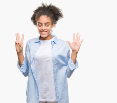 Genç afro Amerikan kadın gösterilen ve parmakları ile işaret izole arka plan yüzünden kendinden emin ve mutlu gülümseyerek süre sekiz numara.