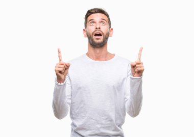 Yakışıklı delikanlı izole arka plan üzerinden hayran ve yukarıya bakıp parmakları ile işaret şaşırttı ve silah kaldırdı.