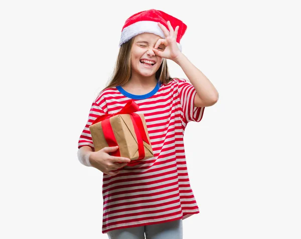 Young Beautiful Girl Wearing Christmas Hat Holding Gift Isolated Background — Stock Photo, Image