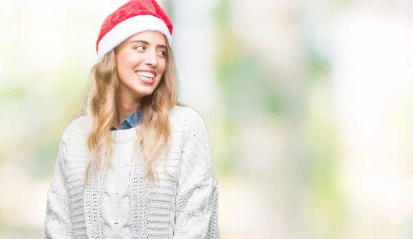 上クリスマス帽子身に着けている美しい若いブロンドの女性は 背景が笑顔で側に自然な表現の顔に離れて見て分離されました 自信を持って笑ってください — ストック写真