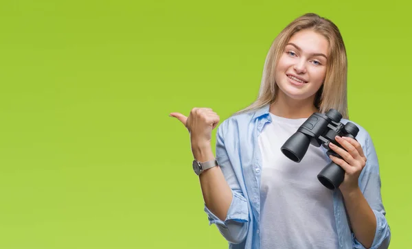 Young Caucasian Woman Holding Binoculars Isolated Background Pointing Showing Thumb — Stock Photo, Image