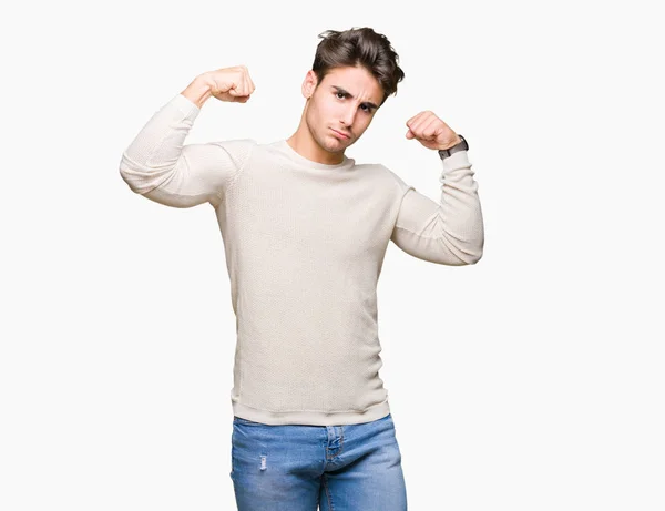 Stock image Young handsome man over isolated background showing arms muscles smiling proud. Fitness concept.