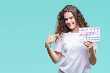 Adet takvim sürpriz yüz işaret parmağı kendini izole arka plan üzerinde tutan genç esmer kız