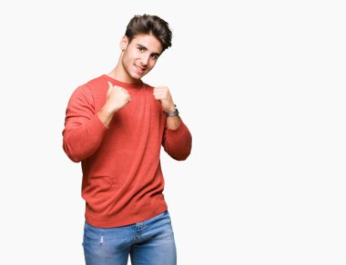 Yüzünde gülümseme ile kendinden emin görünüyorsun, kendini gururlu ve mutlu parmakları ile işaret izole arka plan üzerinde genç yakışıklı adam.