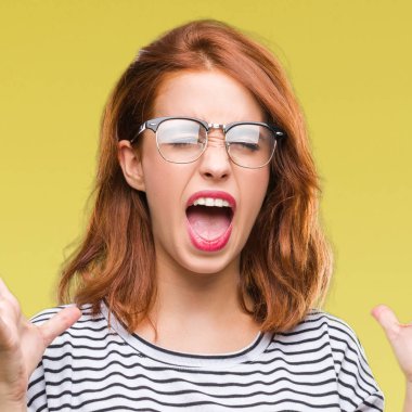 Genç güzel kadın yüzünden kızgın ve silah ile başarı için deli kutluyor gözlük takan izole arka plan ortaya çıkar ve heyecanlı çığlık gözler kapalı. Kazanan kavramı