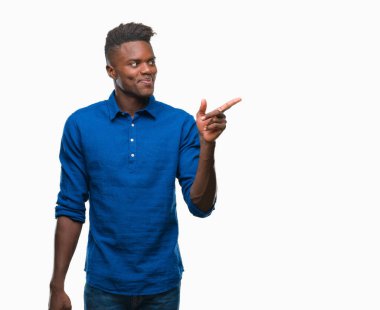 Kameraya bakarak yan el ve parmak ile işaret eden genç Afro-Amerikan adam yüzünde kocaman bir gülümseme ile izole arka plan üzerinde.