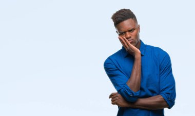 İzole arka plan düşünme seyir üzerinde genç Afro-Amerikan adam yorgun ve sıkılmış çapraz silah depresyon sorunları ile.