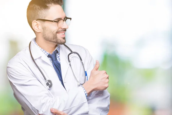 Guapo Joven Doctor Hombre Sobre Aislado Fondo Buscando Orgulloso Sonriendo — Foto de Stock