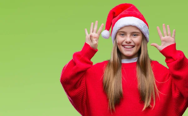 年轻美丽的女孩戴着圣诞节帽子在孤立的背景显示和指向与手指数字九同时微笑自信和快乐 — 图库照片