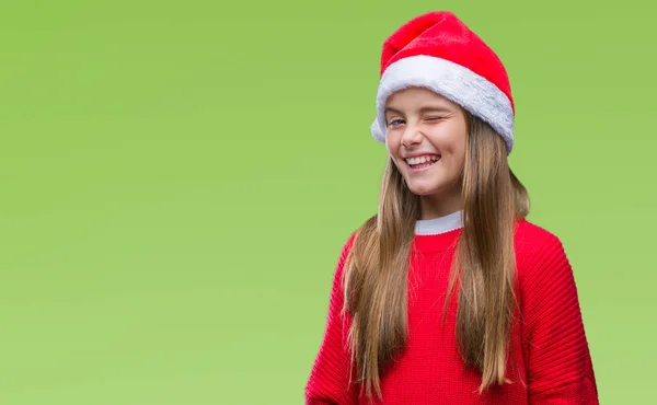 美しい少女のセクシーな表情 明るく 幸せな顔でカメラを見てウィンクしている孤立した背景にクリスマスの帽子をかぶって — ストック写真