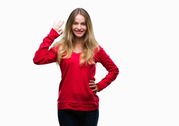 年轻美丽的金发碧眼的女人穿着红色毛衣在孤立的背景微笑积极做确定的迹象与手和手指 成功的表达 — 图库照片