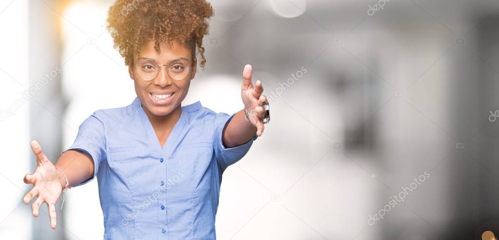 Beautiful young african american business woman over isolated background looking at the camera smiling with open arms for hug. Cheerful expression embracing happiness.