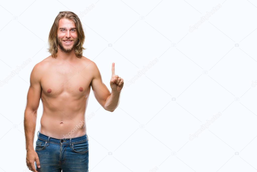 Young handsome shirtless man with long hair showing sexy body over isolated background showing and pointing up with finger number one while smiling confident and happy.