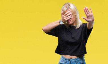 Genç güzel sarışın kadın izole elleriyle gözlerini kapsayan arka plan ve stop jest ile acı ve korku ifadesi. Utandım ve negatif kavramı.