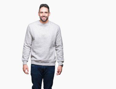 Yüzünde mutlu ve güzel bir gülümseme ile izole arka plan üzerinde sweatshirt giyen genç yakışıklı adam. Şanslı kişi.