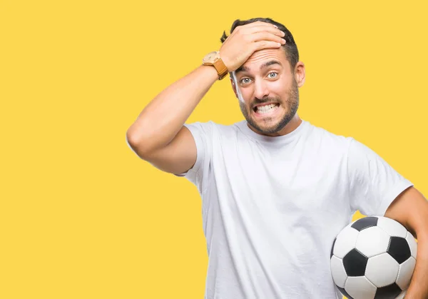 Jovem Homem Bonito Segurando Bola Futebol Sobre Fundo Isolado Estressado — Fotografia de Stock