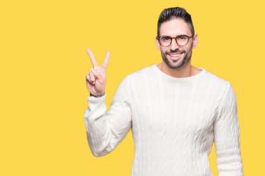 Mutlu yüz zafer işareti yaparken kameraya göz kırpıyor ile gülümseyen izole arka plan üzerinde gözlük takan yakışıklı delikanlı. İki numaralı.