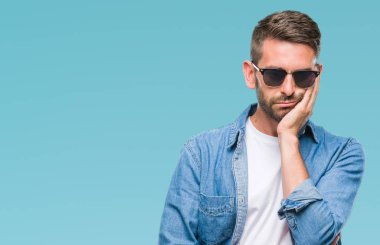 Yakışıklı delikanlı seyir yorgun ve bıkkın ile depresyon sorun Çapraz kollar ile izole arka plan düşünme üzerinde güneş gözlüğü takıyor.