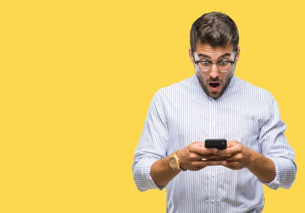 Young Handsome Man Texting Using Smartphone Isolated Background Scared Shock — Stock Photo, Image