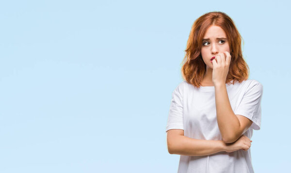 Young beautiful woman over isolated background looking stressed and nervous with hands on mouth biting nails. Anxiety problem.