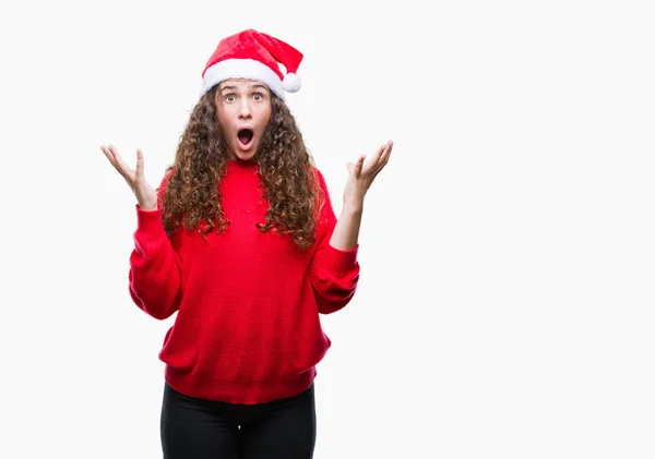上クリスマスの帽子を着ている若いブルネットの少女は 背景を祝う怒って叫んで調達とクローズの目が興奮して腕を成功のために狂気を分離しました 勝者の概念 — ストック写真