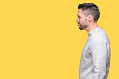 Genç yakışıklı adam giyen kazak izole arka tarafına, seyir üzerinde dinlenmek doğal yüz emin gülümseme ile pozuyla profil.