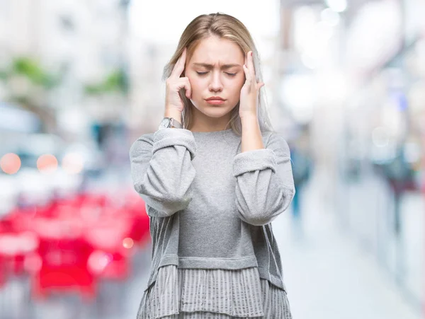 Young blonde woman over isolated background with hand on head for pain in head because stress. Suffering migraine.