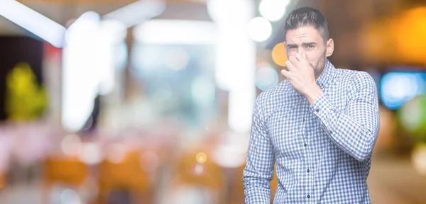 Junger Gutaussehender Mann Mit Isoliertem Hintergrund Der Etwas Stinkendes Und — Stockfoto