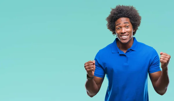 Afro american man over isolated background very happy and excited doing winner gesture with arms raised, smiling and screaming for success. Celebration concept.